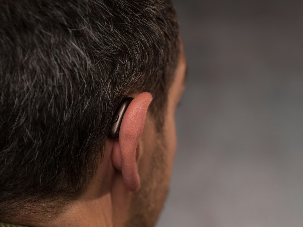 Audiologist programming a new hearing aid during a fitting appointment at Comprehensive Hearing Solutions in Pittsburg, KS