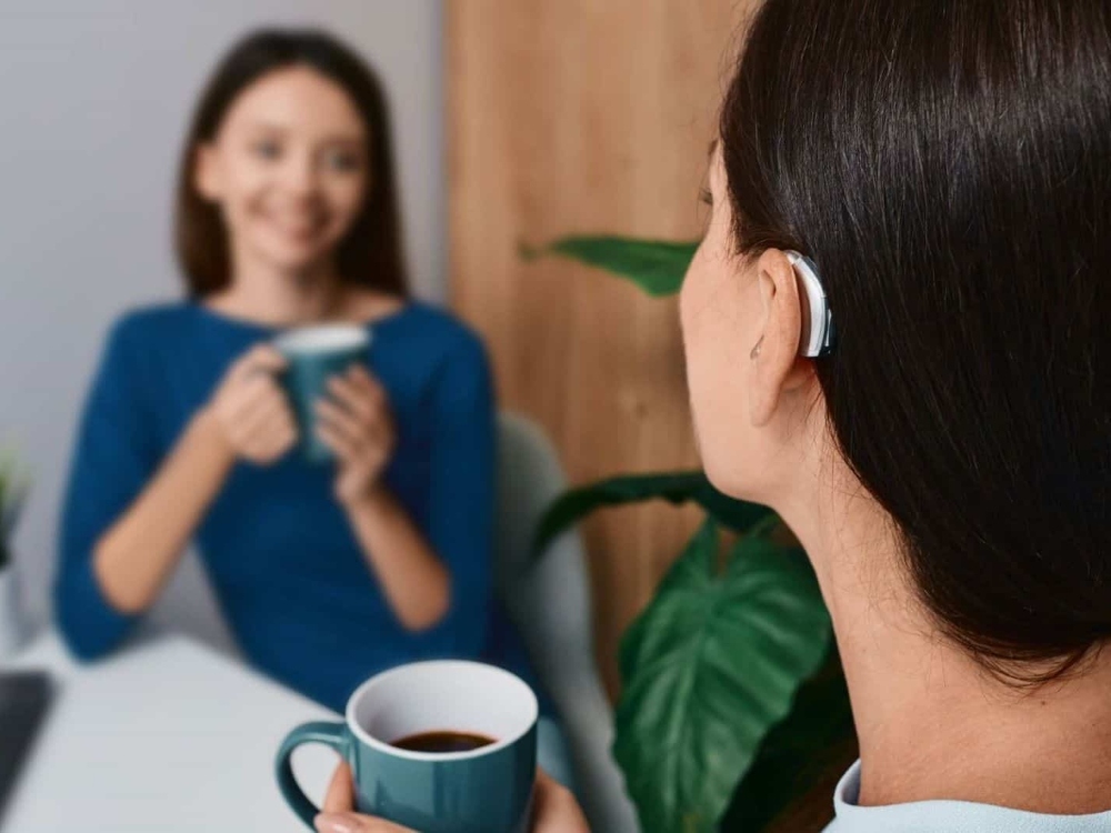 Woman wearing a receiver-in-canal hearing aid, one of the hearing aid styles available at Comprehensive Hearing Solutions in Pittsburg, KS