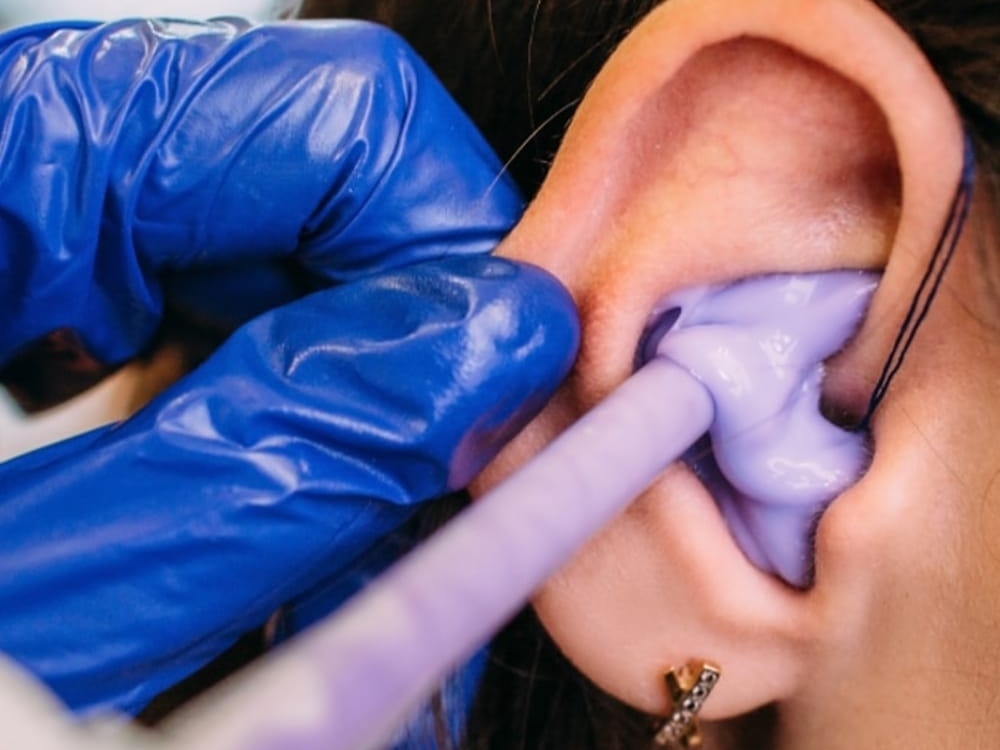 Doctor of Audiology taking a custom ear impression for hearing protection at Comprehensive Hearing Solutions in Pittsburg, KS